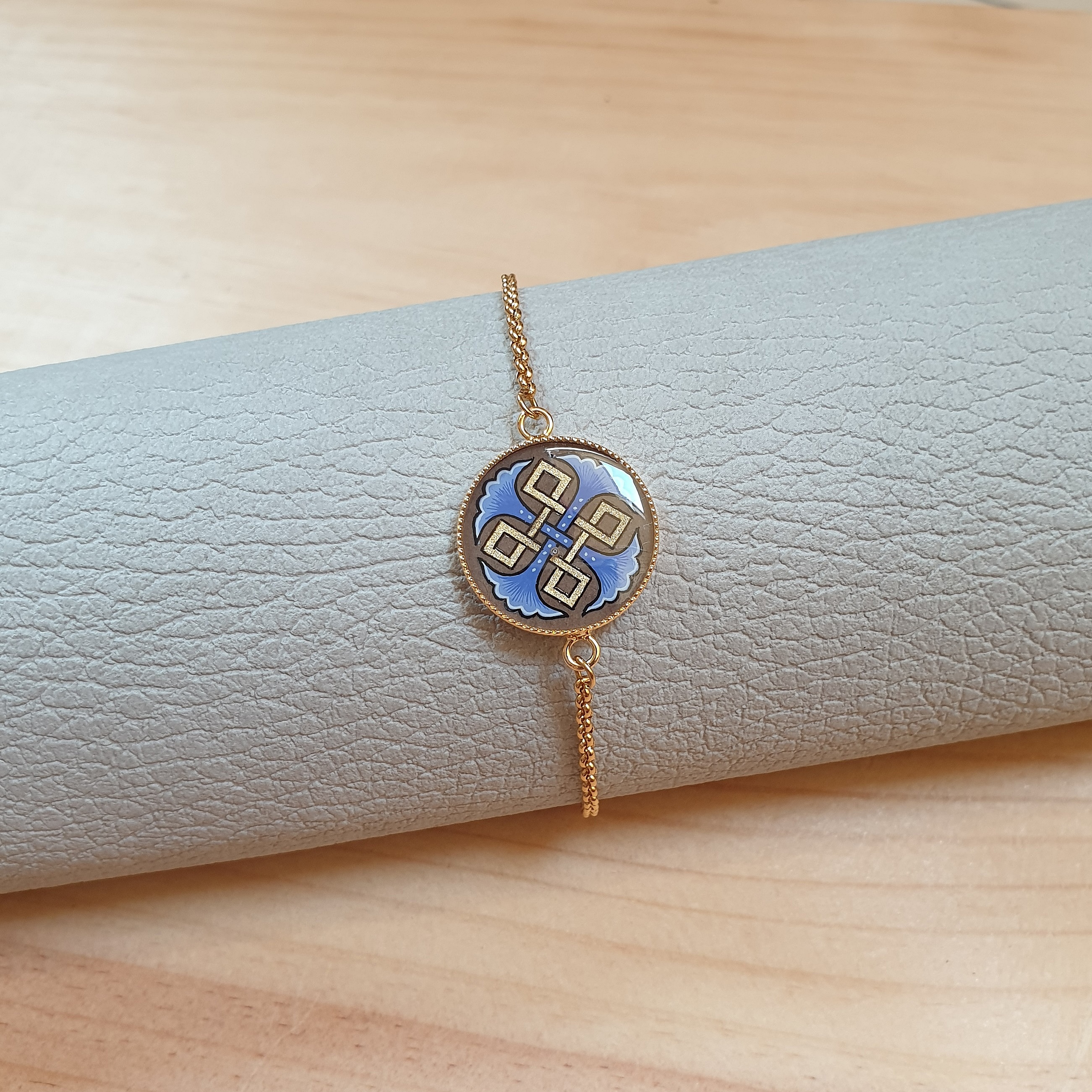 Bracelet r&eacute;glable entrelacs or et palmettes rouges ou bleues