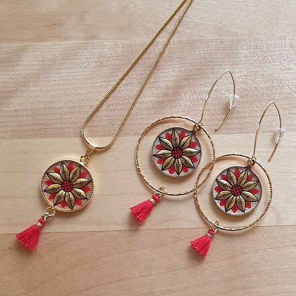 Halskjede med gull/bl&aring;tt blomsteranheng p&aring; gullkjede